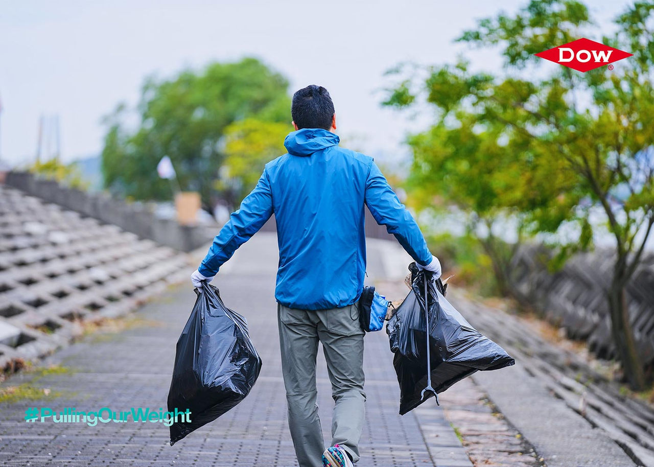 A man carrying trash bags